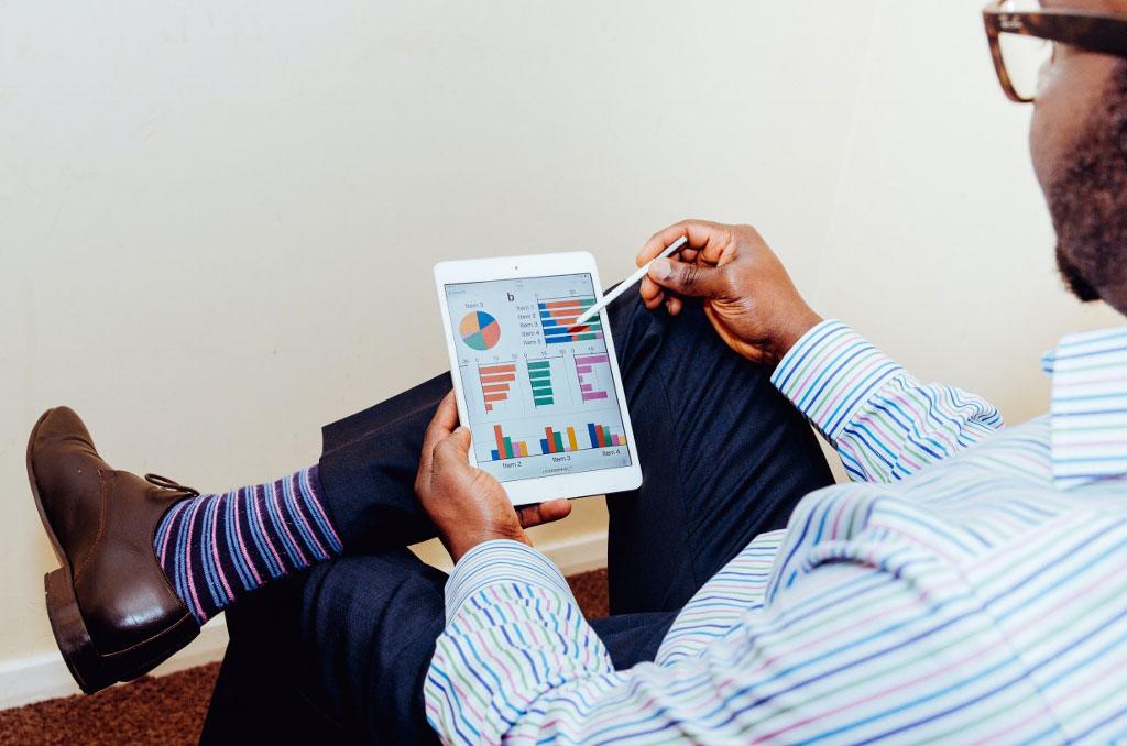 Business man tracking accounts payable performance on his tablet.