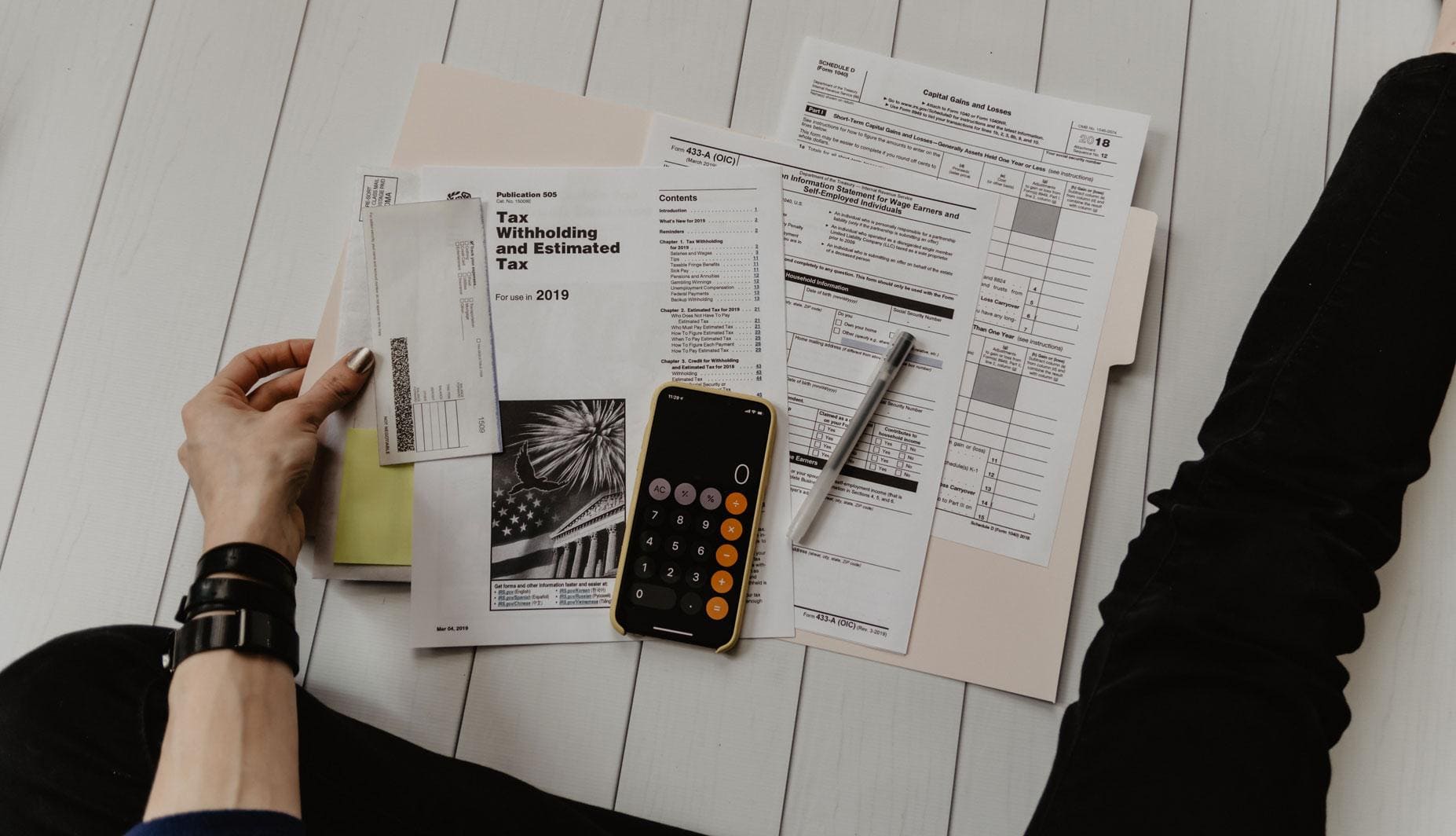 Accounts-Receivalbe-3 accounts receivable paperwork and smart phone out on a wooden table