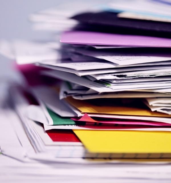 sharon-mccutcheon-tn57JI3CewI-unsplash (600x640) Pile of accounts payable invoices ready to be processed